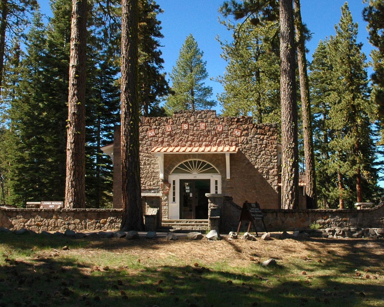 The stone Loomis Museum building among pines